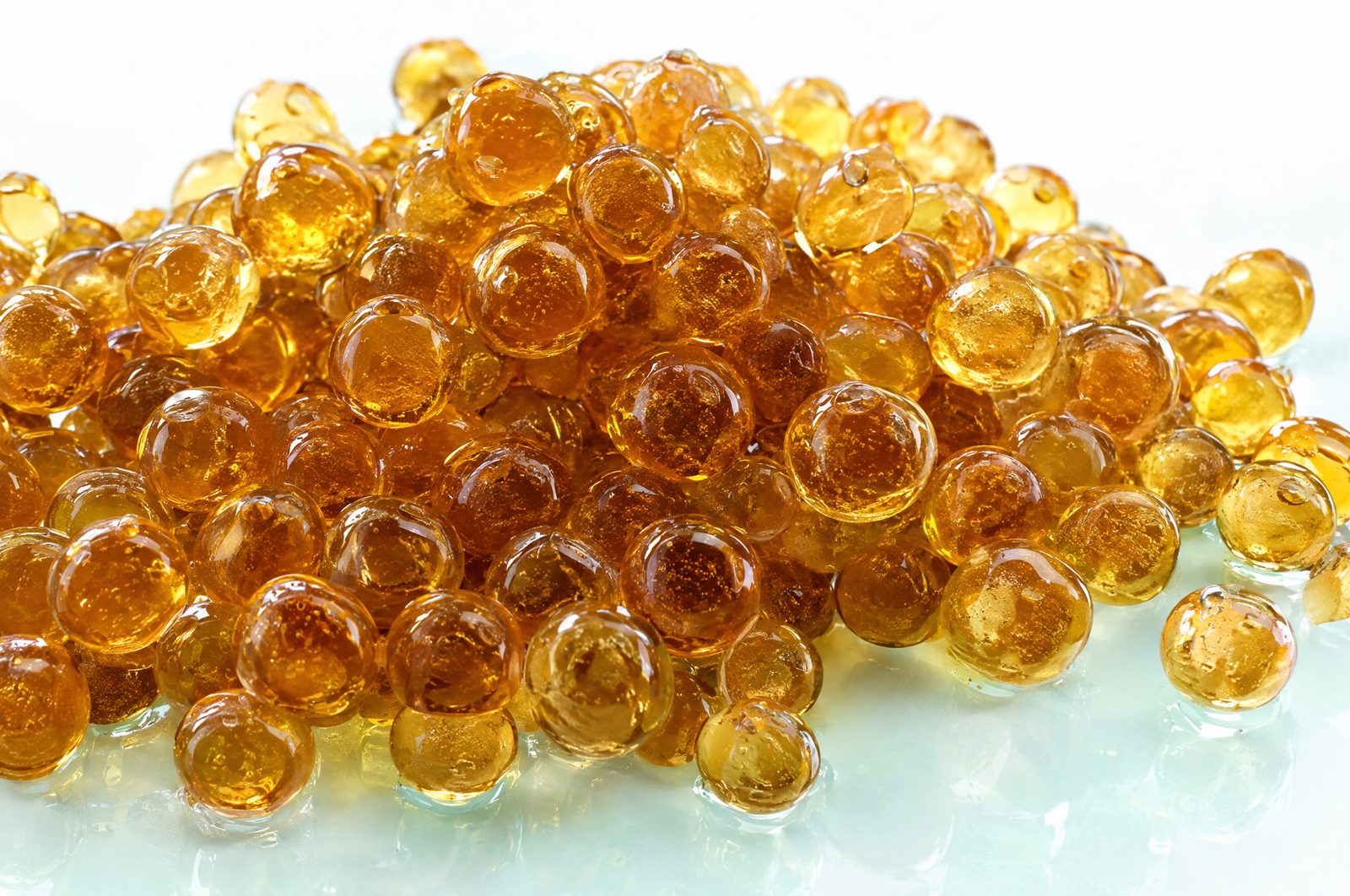 Close-up of a pile of small translucent amber resin beads